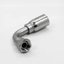 The 04U74P is a shiny metal hydraulic hose fitting with a 90-degree bend, hexagonal end, and circular connector, compatible with 100R1. It is displayed against a plain white background.