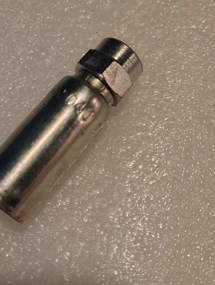 A close-up of the Weatherhead 04U-202 (CS02-4X2) 1/4 hose x 1/8 NPTF female fitting, showing its cylindrical tube and hexagonal nut on a textured white surface.
