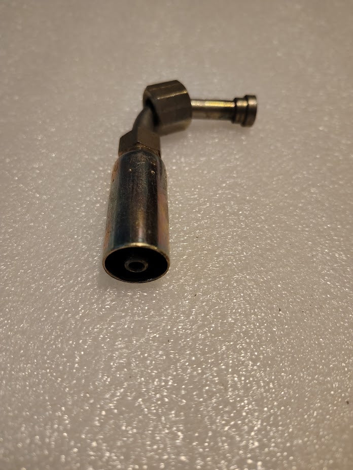 The 04U-A64 | Weatherhead 1/4 Hose x 1/4 ORF Female Fitting (CS33-4X4) is a durable, metallic, L-shaped hydraulic hose fitting with a hex nut and cylindrical end, shown on a textured white surface.