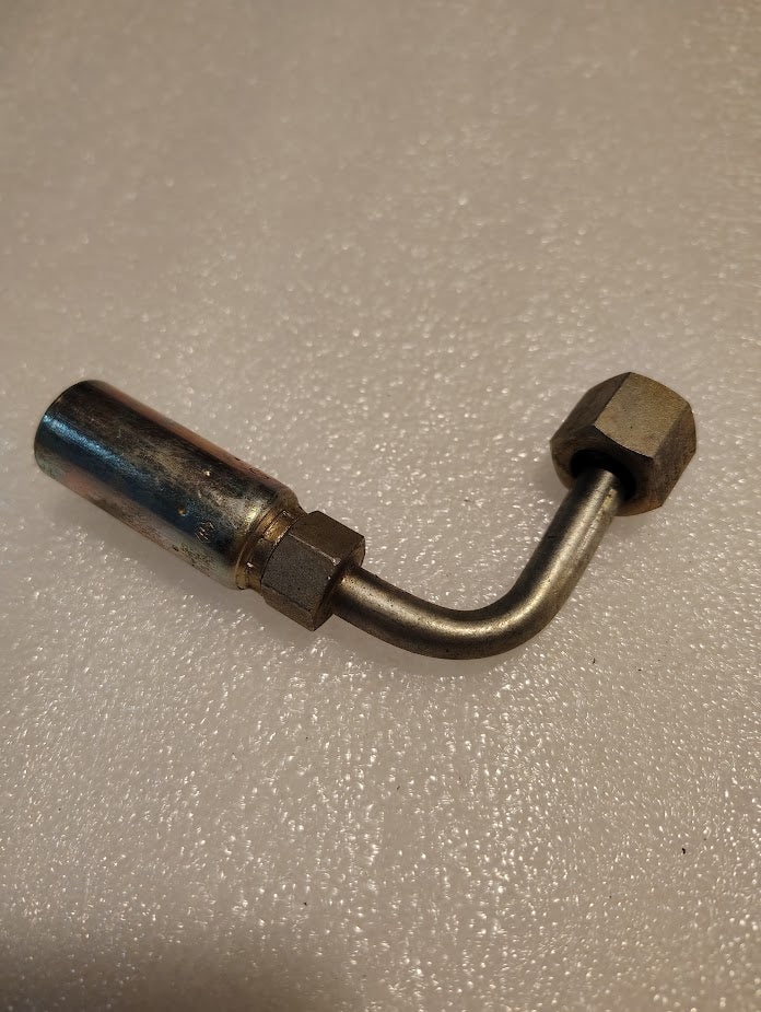 The Weatherhead 04U-A64 (CS33-4X4) 1/4 hose x 1/4 ORF female fitting is a metal right-angle pipe fitting with threaded connectors, suitable for hydraulic hoses or 100R16 hoses, shown on a textured, light surface.