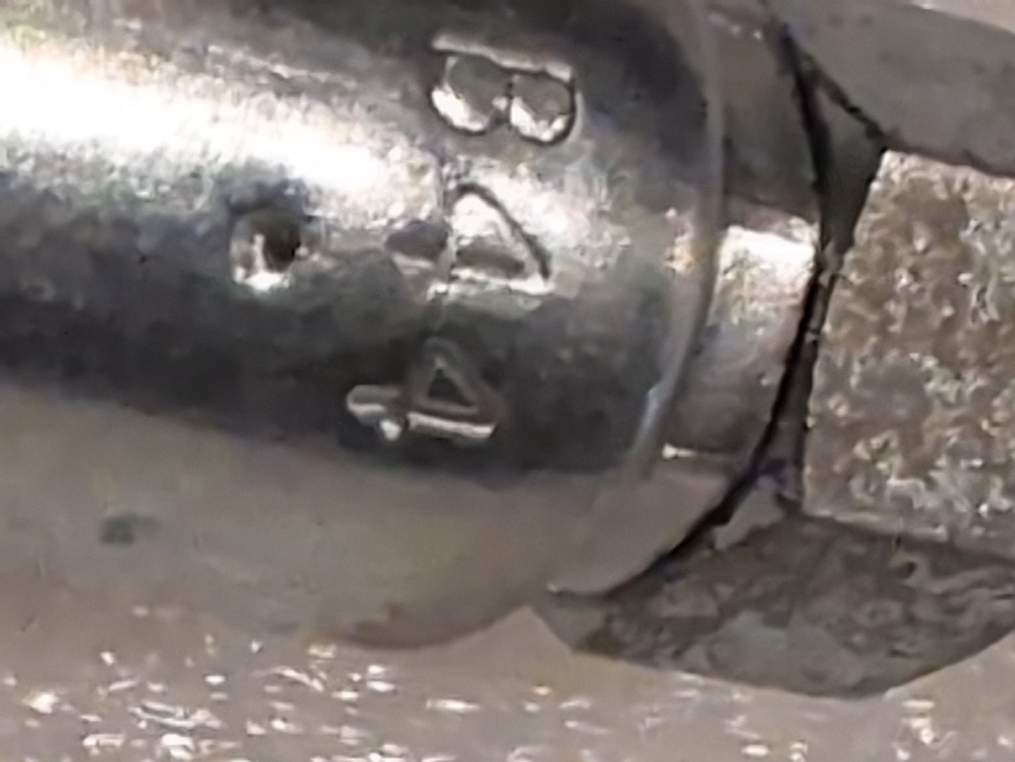 Close-up of a slightly worn, reflective 04U-B44 Weatherhead 1/4 Hose x 1/4 Inverted Male Fitting (CS19-4X4) with B A 4 engraved on the metallic surface.