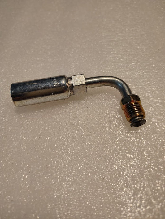 A close-up of a Weatherhead 04U-B65 fitting (1/4 hose x 5/16 inverted male, CS20-4X5) with a curved elbow and threaded ends, resting on a textured, light-colored surface.