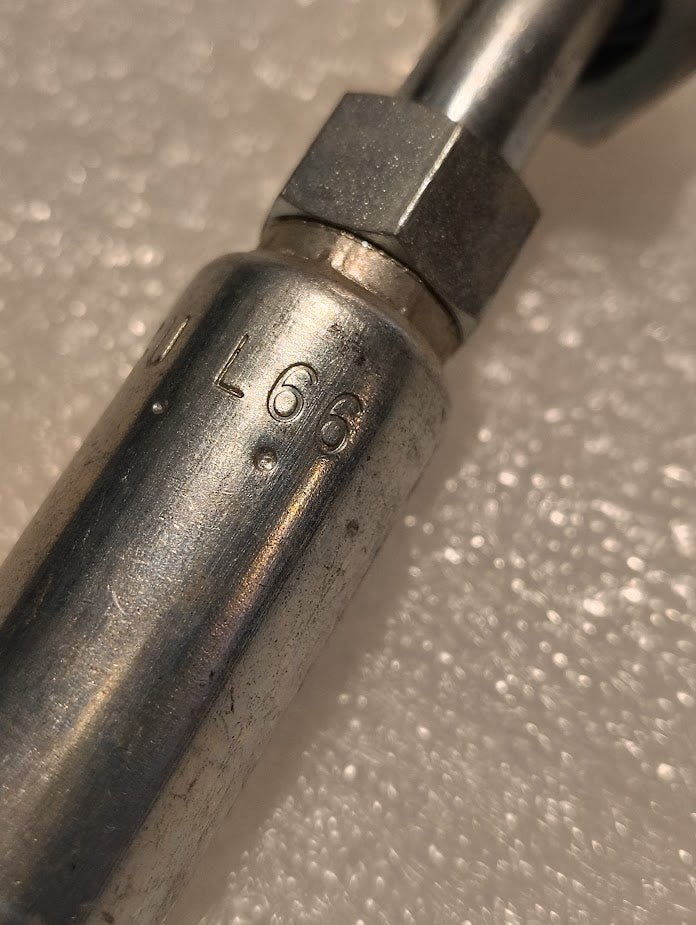 Close-up of an 04U-L66 Weatherhead 1/4 Hose x 3/8 ORF Female Fitting (CS31-4X6) with engraved L66 mark, set on a light textured background—ideal for demanding hydraulic applications.