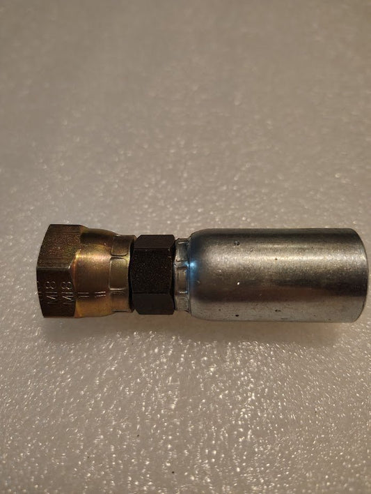 A close-up of the Weatherhead 06U-12C, a 3/8 hose x M18x1.5 DIN female fitting (CS37-6X12), with a brass hexagonal nut and silver end for 100R1 hoses, shown on a textured, light-colored surface.