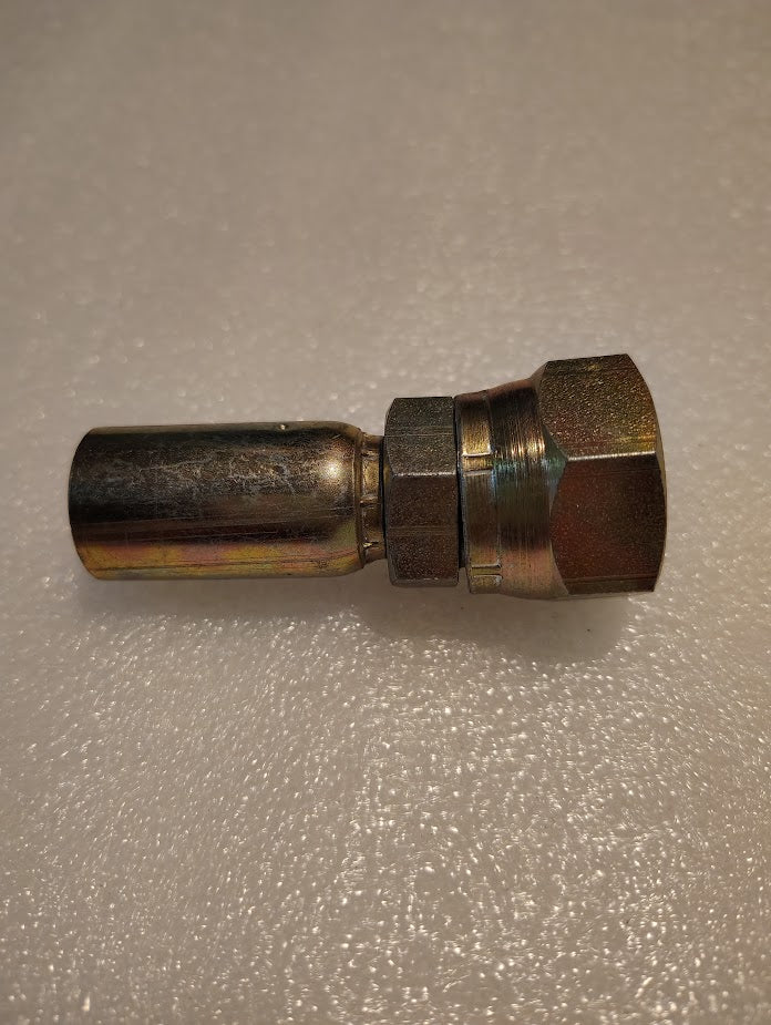 A close-up of a Weatherhead 06U-612 (3/8 Hose x 3/4 JIC Female Fitting, CS09-6X12) with a hexagonal nut, lying on a textured white surface, compatible with Parker and Weatherhead fittings.