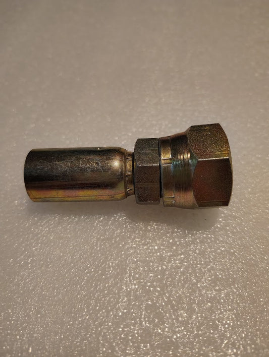 A close-up of a Weatherhead 06U-612 (3/8 Hose x 3/4 JIC Female Fitting, CS09-6X12) with a hexagonal nut, lying on a textured white surface, compatible with Parker and Weatherhead fittings.