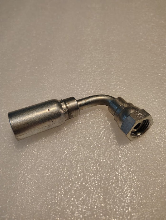 The Weatherhead 06U-62D CS44-6X12 is a metallic 3/8 hose x M18x1.5 DIN female fitting with a 90° bend, compatible with 100R series hoses, featuring a threaded hex end and cylindrical connector on a textured white surface.