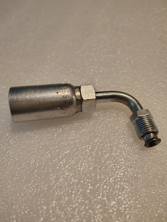 The 06U-B65 Weatherhead 3/8 Hose x 5/16 Inverted Male Fitting (CS20-6X5) features a 90° bend, hex nut, and threaded ends, and is displayed on a textured light surface.