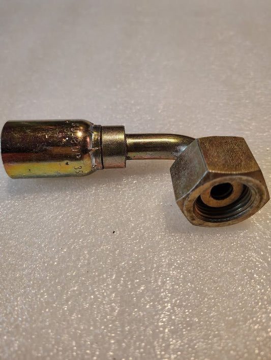A close-up of a Weatherhead 08U-80P 1/2 Hose x 5/8 BSPP Female Fitting (CS46-8X10), featuring a bent tube and large hex nut, designed for 100R1 hoses, rests on a textured white surface.