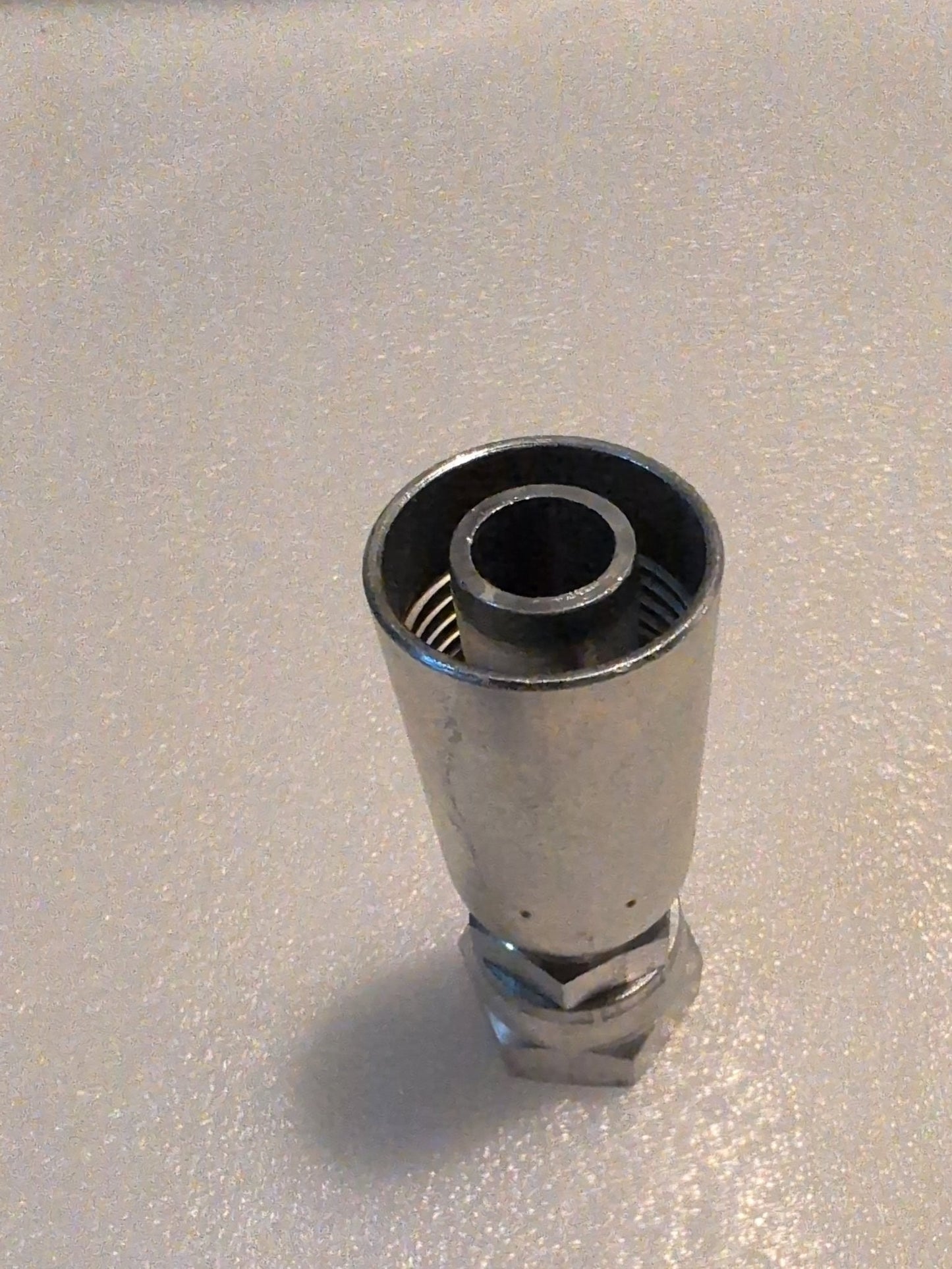 The image showcases the 10U-612, a metallic cylindrical Weatherhead component, designed as a 5/8 hose x 3/4 JIC female straight swivel fitting with threads and a smaller central opening, set against a neutral speckled background.