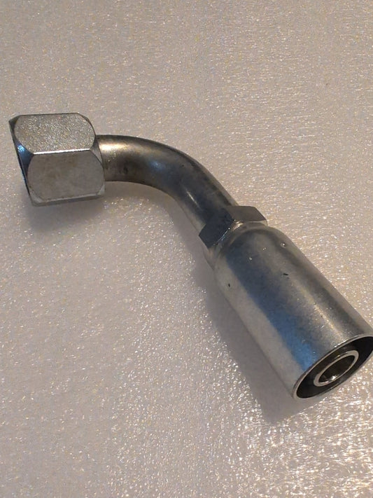 The Weatherhead 10U-672 (CS26-10X12) is a metal 5/8 hose x 3/4 JIC female fitting with a bent tube and hex nut, compatible with 100R1 hoses, shown on a textured light surface.