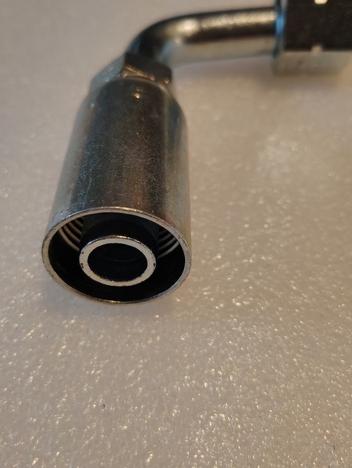 Close-up of a 10U-A70 Weatherhead 5/8 Hose x 5/8 ORF Female Fitting (CS33-10X10) on a textured white surface, showing the circular opening and interior details.