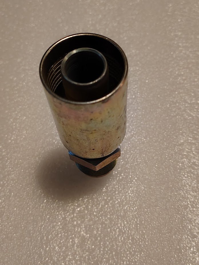 A Weatherhead 12U-312 fitting—3/4 hose x 3/4 SAE male with internal threading and hex nut base—is shown upright on a textured, light-colored surface.