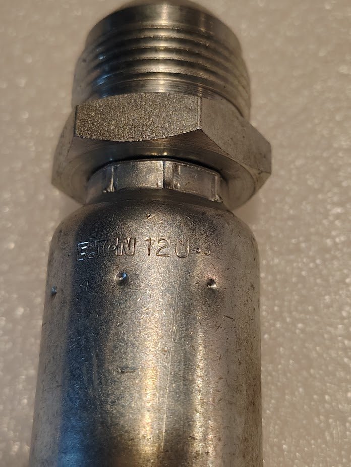 A close-up shows the Weatherhead 12U-516 fitting, a 3/4 hose x 1 SAE male hydraulic part (CS08-12X16) with threading and a hexagonal nut. Eaton 12U is stamped on the side against a light, textured background.