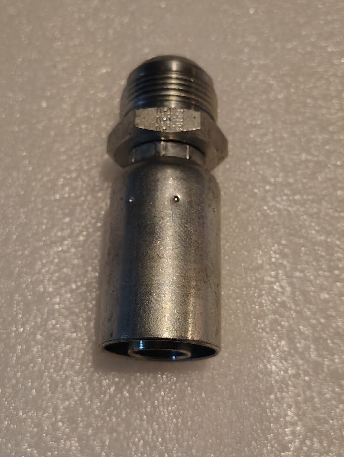 A Weatherhead 12U-516 fitting with a threaded hexagonal nut and smooth cylindrical body lies on a textured white surface. Silver in color, this solid hydraulic hose fitting is built for optimal performance and compatibility.