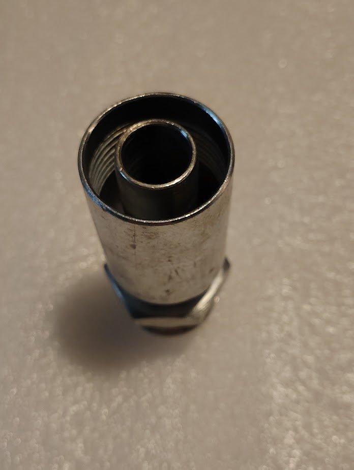 A close-up of the Weatherhead 12U-516, a 3/4 hose x 1 SAE male fitting (CS08-12X16), with internal threads, shown on a textured white surface.