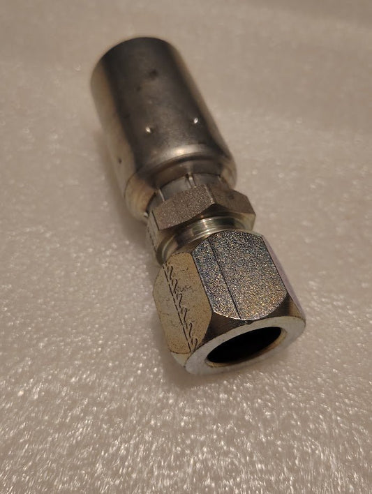 A close-up of the Weatherhead 12U-762 fitting (3/4 hose x 3/4 compression, CS28-12X12) shows its metallic hex nut and cylindrical end on a textured light-colored surface, designed for use with compatible hoses.