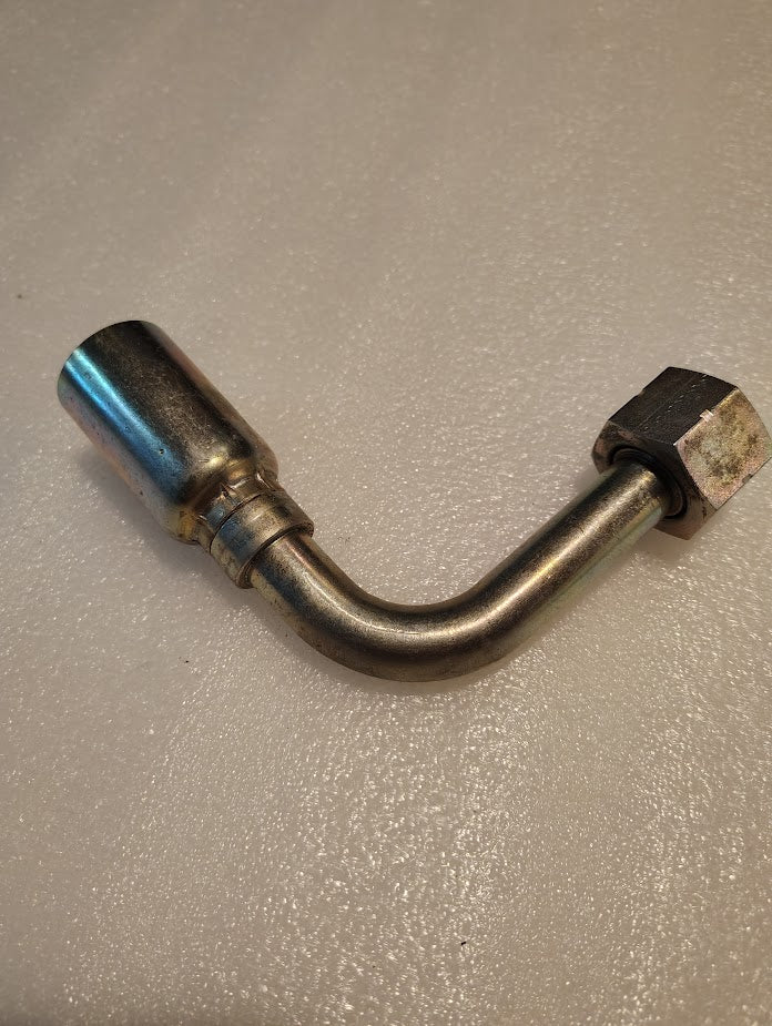The 12U-A72 Weatherhead 3/4 Hose x 3/4 ORF Female Fitting (CS33-12X12) is a metal pipe fitting with a 90-degree bend, cylindrical connector, and hex nut, typically used for hydraulic hose fittings like 100R1 hoses.