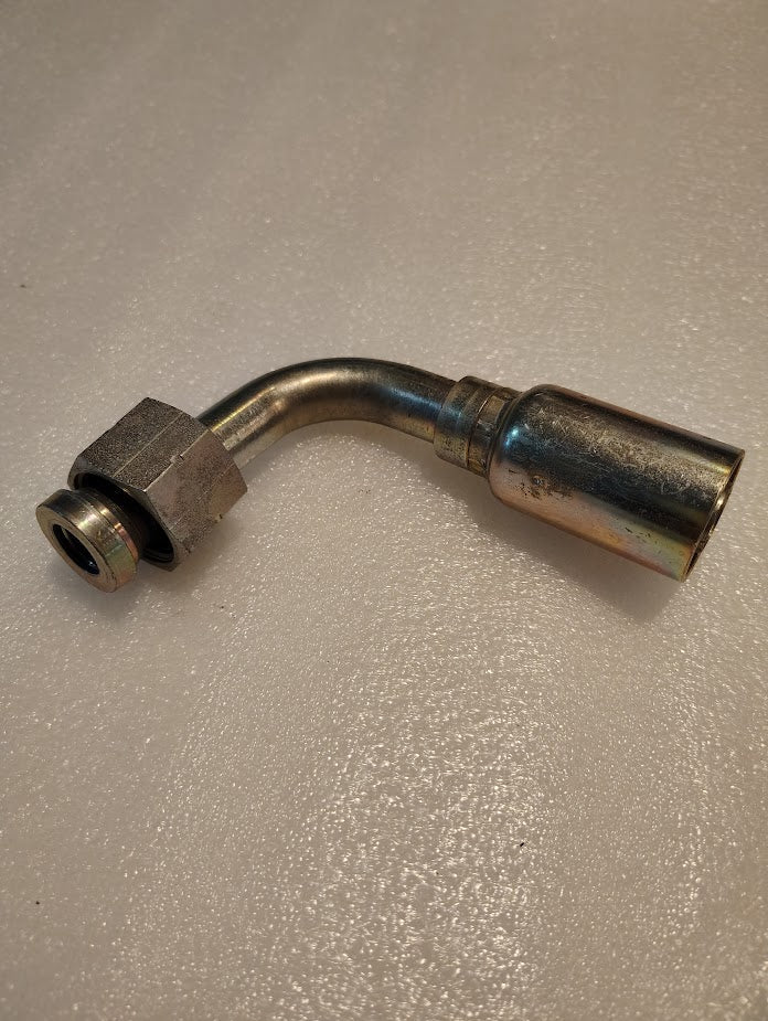 A Weatherhead 12U-A72 3/4 Hose x 3/4 ORF Female fitting (CS33-12X12) with a 90-degree bend is shown on a light textured surface; it features a hex nut, cylindrical coupler, and suits 100R1 hoses.