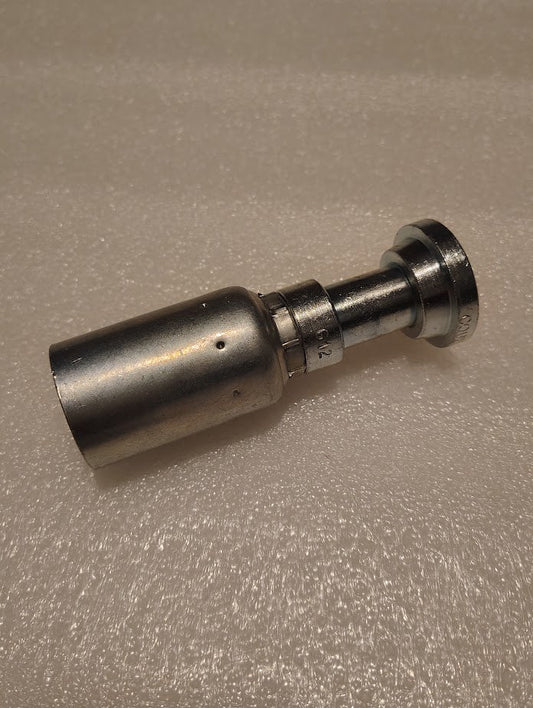 A stainless steel cylindrical tool for installing the 12U-G12 Weatherhead 3/4 Hose x 3/4 Code 61 Flange Fitting (CS47-12X12) on compatible hydraulic hose, shown on a textured, light-colored surface.