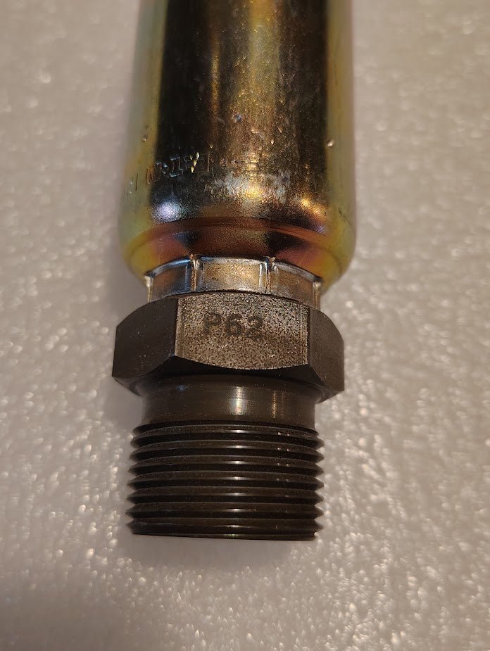 A close-up of the 12U-P62 Weatherhead 3/4 Hose x 3/4 BSPT Male Fitting (CS36-12X12) with a shiny cylindrical body and dark threaded hexagonal end, shown on a textured white surface.