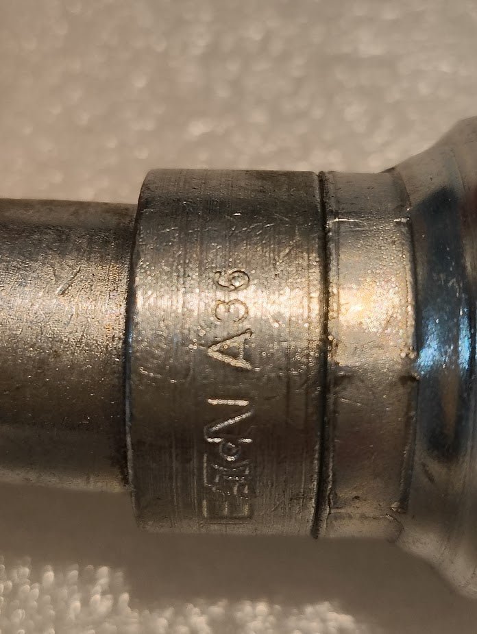 Close-up of a Weatherhead 16U-A36 1 Hose x 1 ORF Female Fitting (CS32-16X16), metallic with engraved markings, shown against a textured light-colored background.