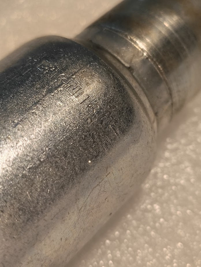 Close-up of the 16U-A36 | Weatherhead 1 Hose x 1 ORF Female Fitting (CS32-16X16), featuring a worn, textured metallic surface with faint engravings and threaded section, positioned on a white, slightly textured background.