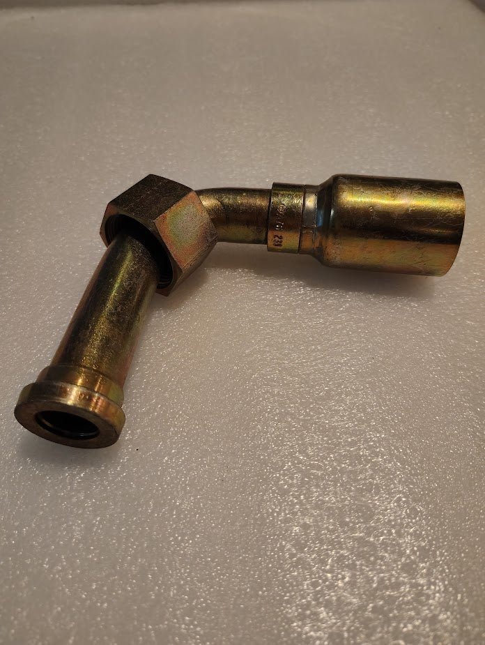 The Weatherhead 16U-A76 is a 1 hose x 1 ORF female metallic fitting with a 90-degree bend and hex nut, resting on a textured white surface—compatible with Parker fittings for reliable connections. Model: CS33-16X16.