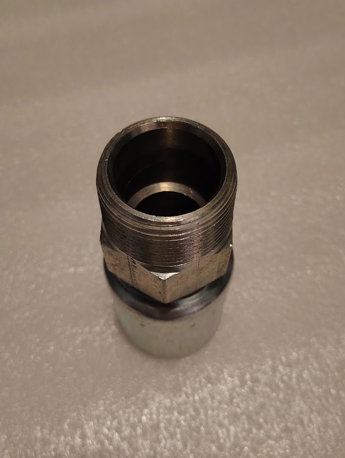 A Weatherhead 20U-120 connector, featuring a metallic hex bolt design, sits upright on a light-textured surface. Its shiny new appearance is ideal for hydraulic hose fittings.