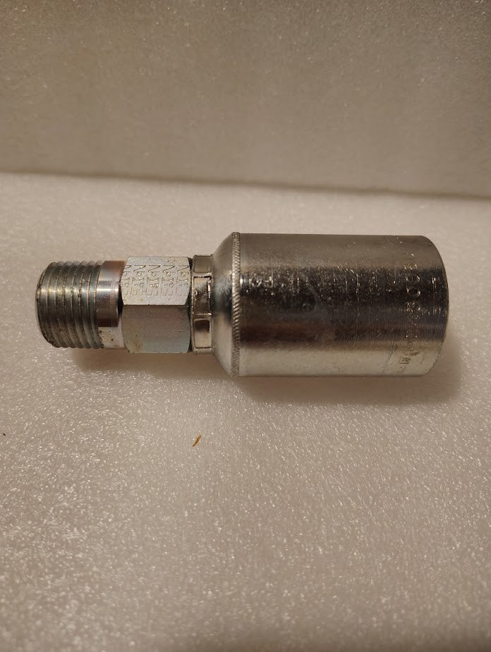 The 43008U-108 Weatherhead 1/2 Hose x 1/2 NPTF Male Fitting (GW01-8x8) features a threaded male end and large cylindrical body, shown lying on a textured white surface.