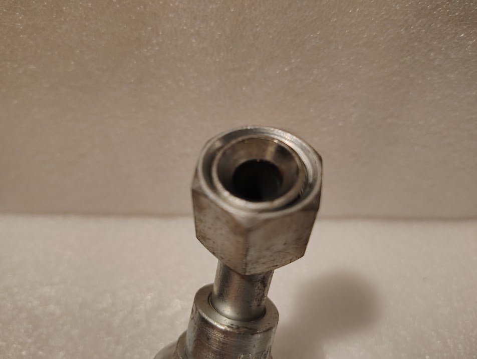 Close-up of Weatherhead 43008U-688, a 1/2 hose x 1/2 JIC female fitting (GW25-8x8), featuring a hexagonal metal nut on a cylindrical body, set against a textured light background.