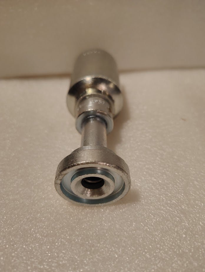 A close-up of the Weatherhead 43008U-G08, a 1/2 hose x 1/2 Code 61 flange fitting (GW47-8x8), with a hexagonal end and cylindrical body, shown on a textured off-white surface—perfect for hydraulic hose applications.
