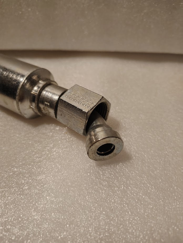 Close-up of a 43008U-L68 Weatherhead 1/2 Hose x 1/2 ORFS Female Fitting (GW31-8x8) with hexagonal nut, partially unscrewed, resting on a textured white surface—fits various hose styles.