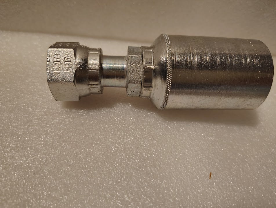 A close-up of a shiny Weatherhead 43008U-S68 1/2 Hose x 1/2 ORFS Female Fitting (GW30-8x8) with engraved markings and threading on one end, displayed on a textured white surface.