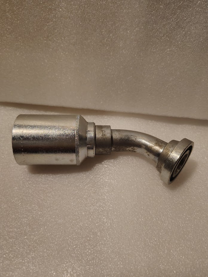 A close-up of the 43012U-G42 Weatherhead 3/4 Hose x 3/4 Code 61 Flange Fitting (GW50-12x12) with a 90-degree bend, resting on a textured, light-colored surface.