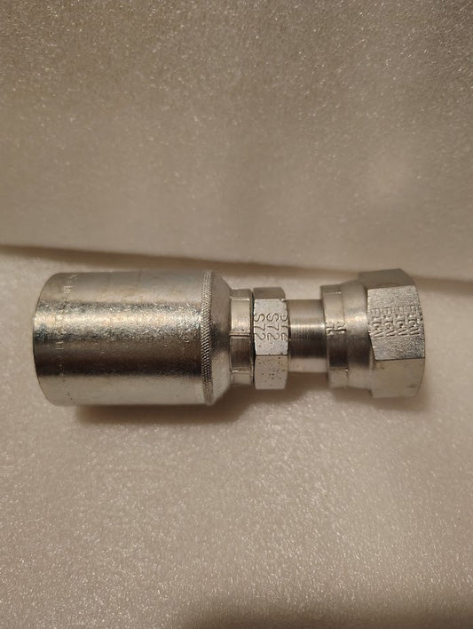 A close-up of a Weatherhead 43012U-S72 GW30-12x12 fitting (3/4 hose x 3/4 ORFS female) with threaded ends and engraved hex, shown on a textured white surface.