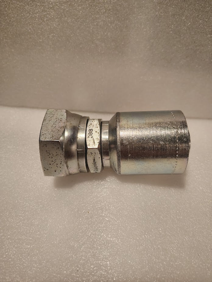 A close-up of the 43016U-80C | 1 Hose x M42x2.0 DIN Heavy (Metric S) Swivel Fitting - Straight, featuring a hex nut and cylindrical, shiny silver body on a white textured surface. Model: GW38-16x30.