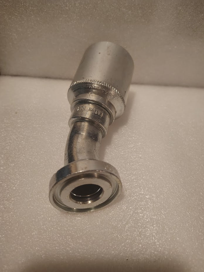 A close-up of a 43016U-H23 | 1 Hose x 1 Code 61 Flange Fitting - 30° bend (GW49-16x16), a metal hydraulic connector with threaded end, shown on a white textured surface.