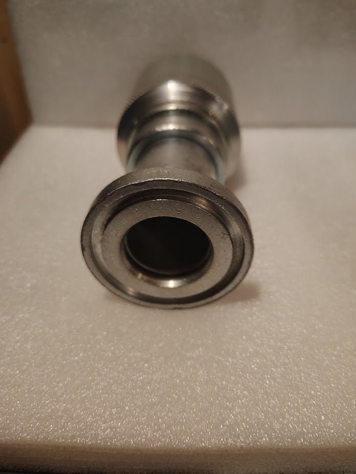 A close-up of a 43024U-G24 | 1 1/2 Hose x 1 1/2 Code 61 Flange Fitting (Straight) is shown vertically on foam, with the open end facing the camera.