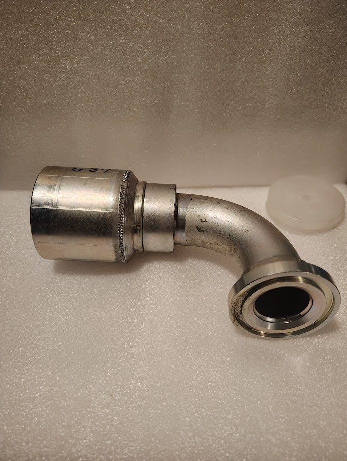 The 43024U-G84 | 1 1/2 Hose x 1 1/2 Code 61 Flange Fitting with a 90-degree bend and textured grip (GW53-24x24) is shown on a white foam background.