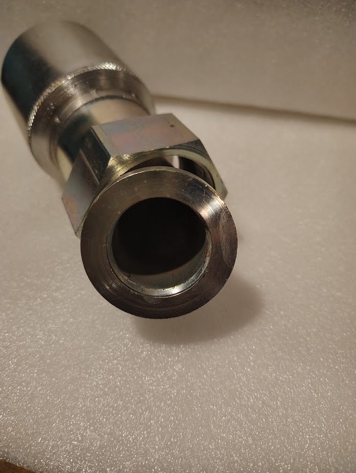 Close-up of a 43024U-L84 | 1 1/2 Hose x 1 1/2 ORFS Swivel Fitting with a 45° bend (GW31-24x24), featuring a hexagonal nut and shown unused on white foam, ideal for hydraulic hose fittings in industrial applications.