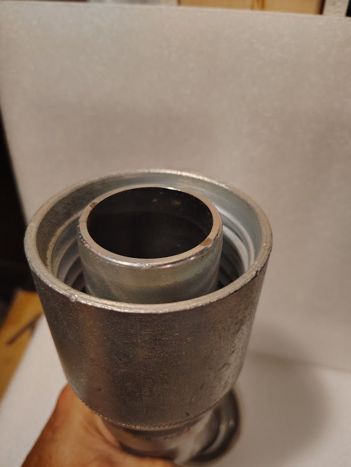 A close-up of the 43032U-D62, a 2 Hose x 2 Code 62 Flange Fitting with a 45° bend (GW61-32x32), showing its nested cylindrical design against a white background.