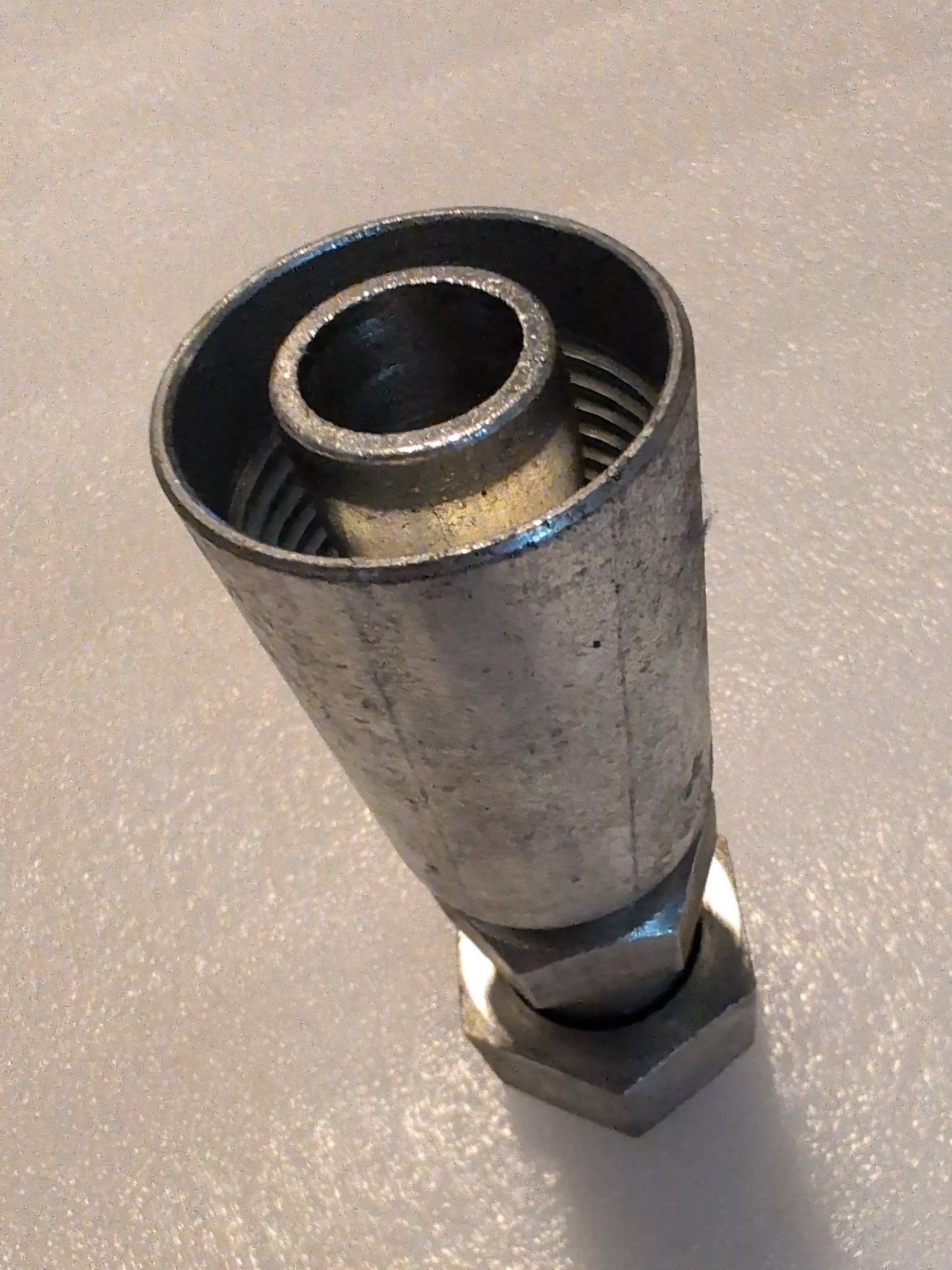 The Weatherhead 12U-S76 straight swivel fitting with a 3/4 hose x 1 ORF female connection stands upright, showcasing its robust utility for plumbing or industrial use. Its metallic surface has a slightly tarnished appearance, highlighting its function in hydraulic systems.