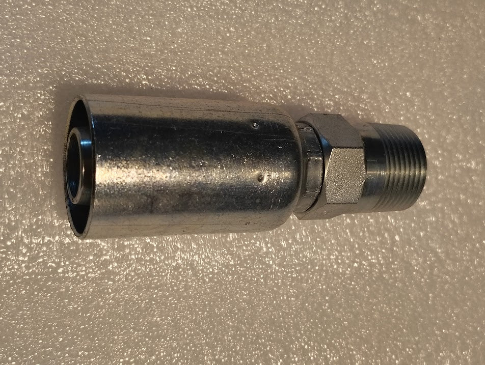 A 12U-162 Weatherhead 3/4 Hose x 3/4 BSPT Male Fitting with a threaded end and cylindrical body sits on a textured white surface. It gleams under overhead lighting, showcasing its industrial design and craftsmanship.