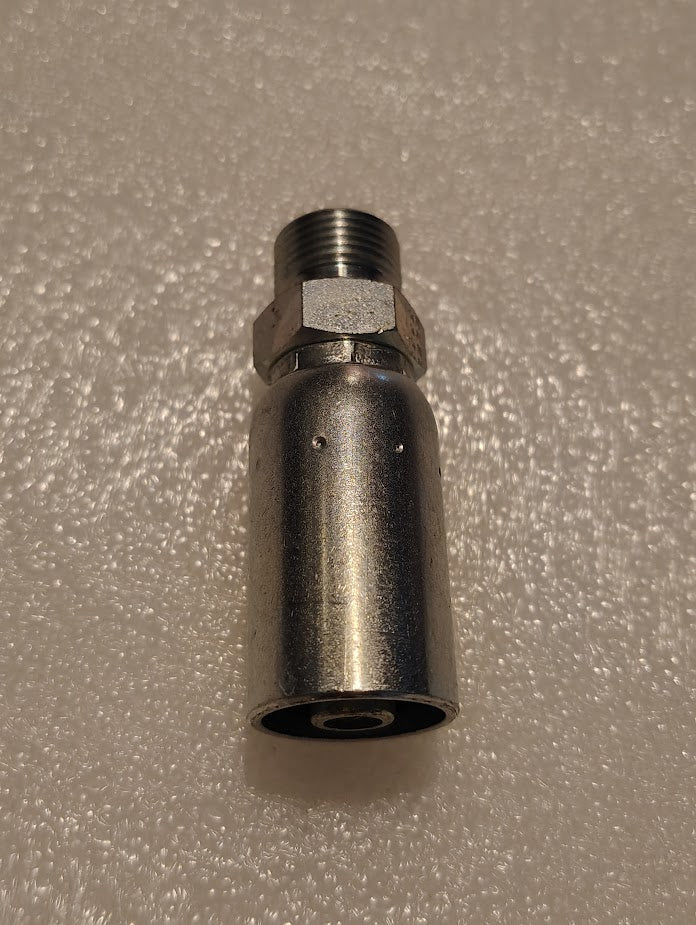 A close-up of an 06U-P56 Weatherhead fitting on a textured surface showcases its cylindrical body, hexagonal nut, and threaded ends, reflecting light smoothly.
