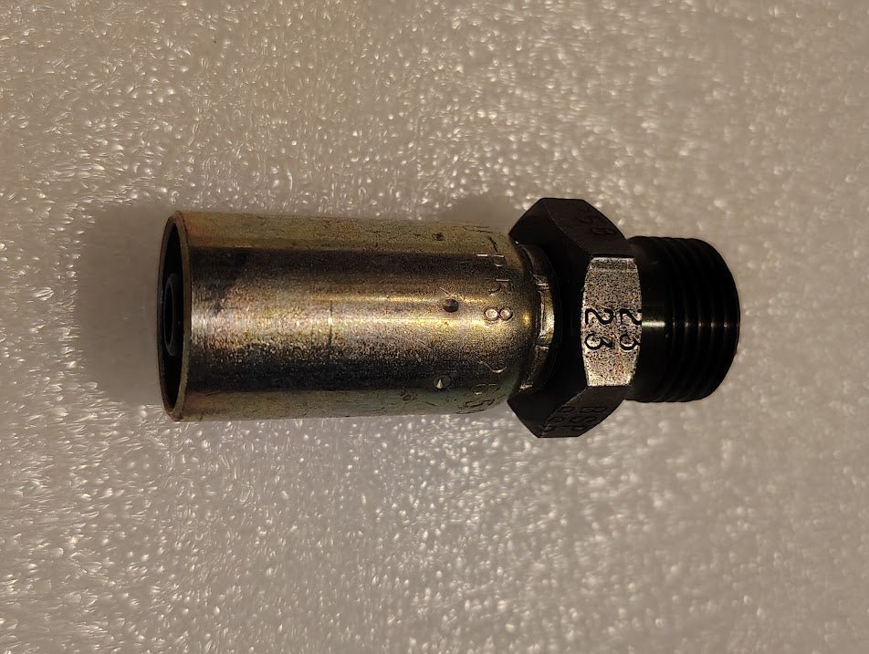 A 06U-P58 fitting is depicted against a textured white background. This Weatherhead fitting, silver and cylindrical with threaded ends, seamlessly connects pipes or hydraulic hoses.