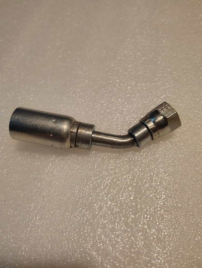 The 06U-10D Weatherhead fitting, a 3/8 hose x M16x1.5 DIN female fitting with a 45° swivel design and hexagonal nut for 100R1 hoses, rests on a textured surface.