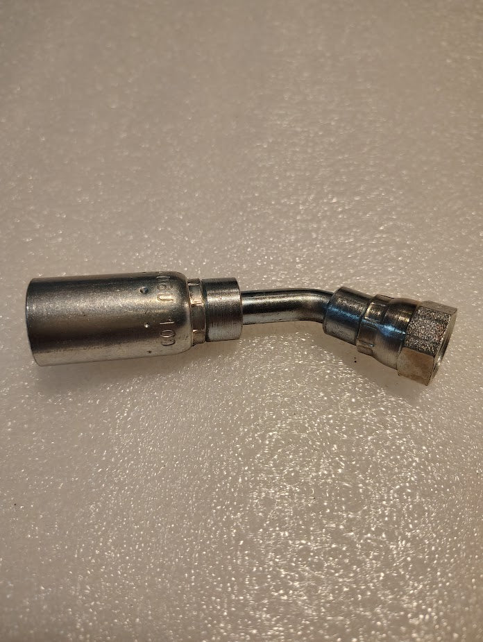 A 06U-10D Weatherhead fitting with a 3/8 hose and M16x1.5 DIN female threads rests on a textured, light surface. This stainless steel, 45-degree swivel fitting resembles interchangeable connectors for versatile applications.