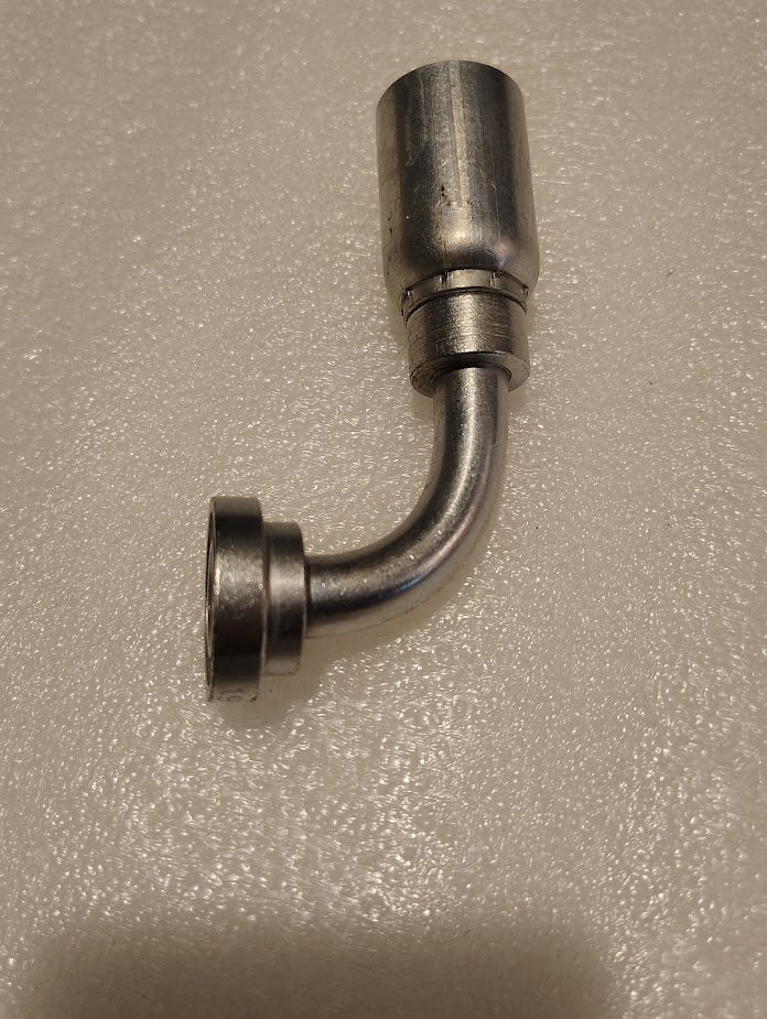 A Weatherhead 08U-G71 1/2 hose x 1/2 Code 61 flange fitting - 90 with a cylindrical top, angled curve, and flat circular base lies on a textured white surface, seamlessly connecting to 100R style hoses for efficient fluid flow.