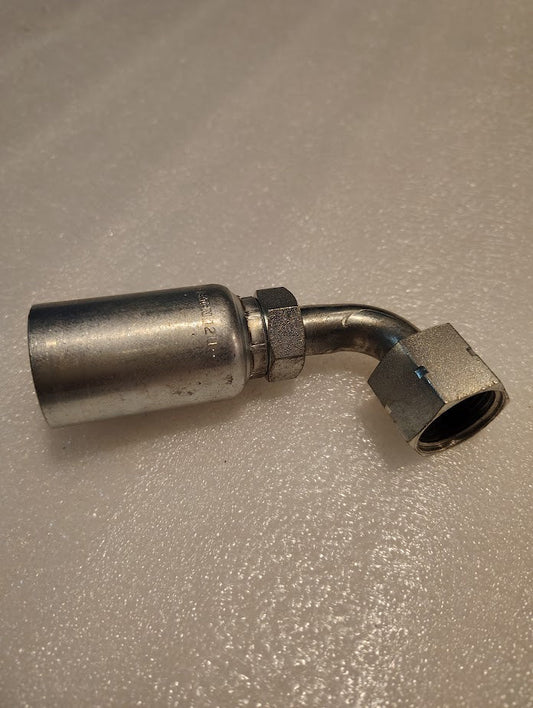 A 12U-A30 Weatherhead fitting with a 3/4 hose x 5/8 ORF female swivel elbow joint and hexagonal nut on a textured surface, resembling hydraulic hose fittings. It features a straight section and a 90-degree bent part.